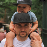 A cap with a straight brim TĒTIS.