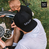 A cap with a straight brim TĒTIS.