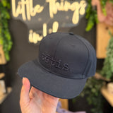 A cap with a straight brim TĒTIS.