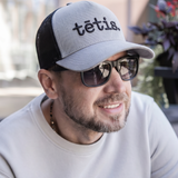 A cap TĒTIS.